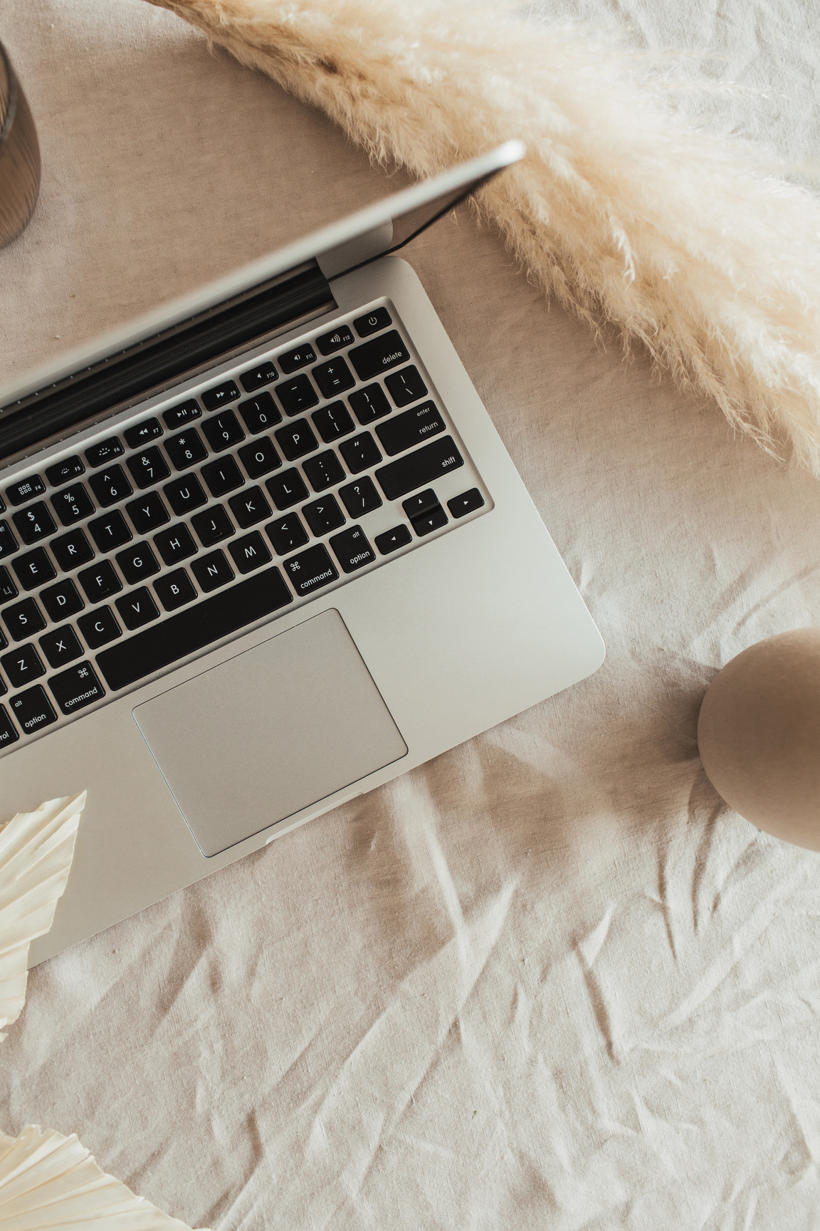 Laptop on a White Bed